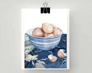 Print of speckled eggs in a blue and white bowl
