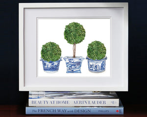 Print of three topiary trees in blue and white antique pots